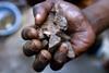 A handful of cassiterite, or tin ore. Armed groups in the DRC are believed to generate $130m a year by trading it. By Mark Craemer