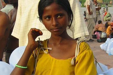 A girl selling plastic containers for carrying Ganges water
