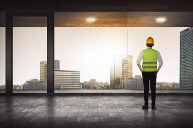 construction worker looking out high rise