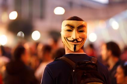A protester wearing a Guy Fawkes mask
