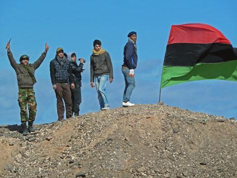 Rebel fighters at positions outside Brega, Libya, show their support for the opposition and their enthusiastic belief that they will overthrow the government in Tripoli, March 10, 2011
